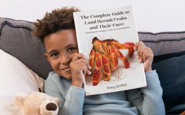 the complete guide to land hermit crabs mockup boy holding book