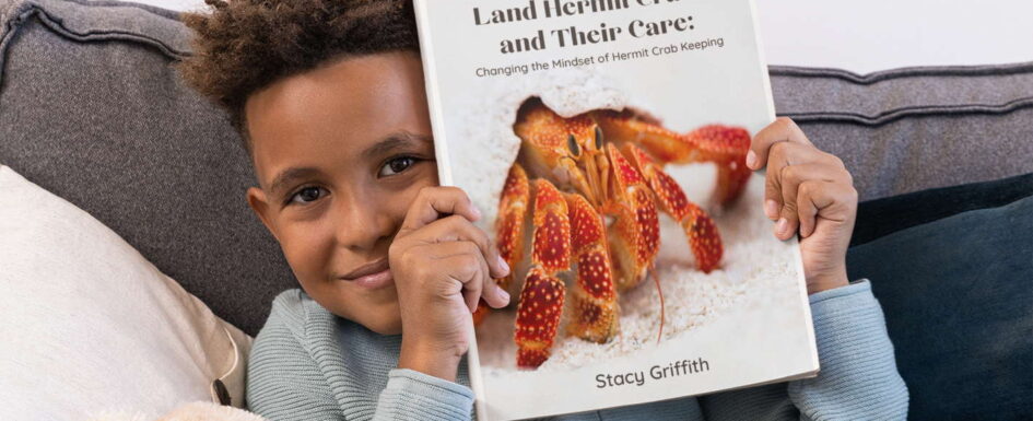 the complete guide to land hermit crabs mockup boy holding book